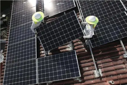  ?? ?? A solar panel system is installed on the roof of a home in Palmetto Bay, Florida. Photograph: Joe Raedle/Getty Images