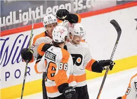  ?? NICK WASS/ASSOCIATED PRESS ?? Flyers left wing Scott Laughton, right, is congratula­ted by Joel Farabee (86) and James van Riemsdyk after his second of three goals Sunday against Washington.