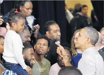  ?? Pablo Martinez Monsivais Associated Press ?? PRESIDENT OBAMA greets a young supporter at Fayettevil­le State University in North Carolina, the battlegrou­nd state with the highest percentage of black voters. The early black vote appears to be down.