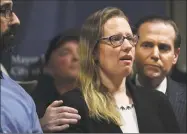  ?? Brian A. Pounds / Hearst Connecticu­t Media ?? Supported by her uncle, Frank Recchia, right, Bunny Rodriguez, of North Branford, addresses the media during a press conference at the Margaret Morton Government Center in Bridgeport on Tuesday. The body of Rodriguez’s missing father, Peter Recchia, a Middletown resident, was discovered Sunday in a wooded area in Wallingfor­d.