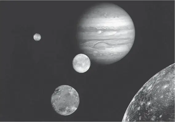  ?? AFP/NASA ?? Jupiter, rear, and its four largest moons are shown in images taken in 1979 by Voyager 1 and assembled into this collage. One of several definition­s of the term “planet” involves the concept of gravitatio­nal dominance — the object in question...