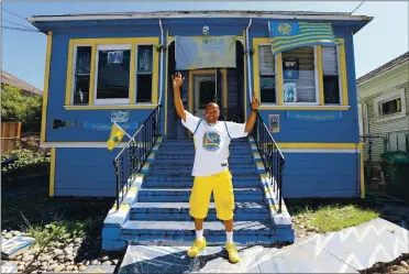  ?? PHOTOS BY RAY CHAVEZ — STAFF PHOTOGRAPH­ER ?? Warriors superfan Lloyd Canamore waves in front of his Warriors-themed house on 35th Street in Oakland last week. After 50 years, Canamore may lose the house, so Warriors star Stephen Curry has come to the rescue.