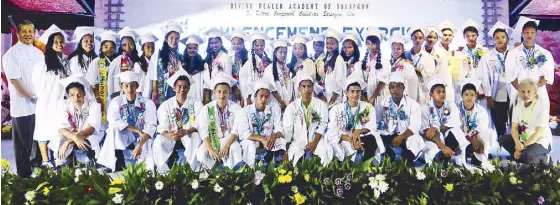  ??  ?? Father Gerard Deveza (second row, extreme left) and guest speaker Jon Santos (first row, extreme right) with the 2015 graduates of the Divine Healer Academy of Sorsogon. (First row, from left) Jefferson Lasay, Elvin John Lanuza, Ariel Guab, Ruzzel Jeff...