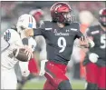  ?? CHRIS O’MEARA — THE ASSOCIATED PRESS ?? Cincinnati quarterbac­k Desmond Ridder looks to pass as he rolls out during the first half of a victory Friday over South Florida in Tampa, Fla.