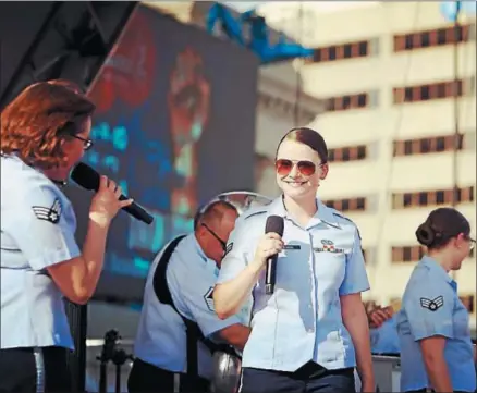  ?? PHOTO COURTESY OF DANA BOWERS ?? Dana Bowers, right, sings with the United States Air Force’s Band of Mid-America in this recent photo.