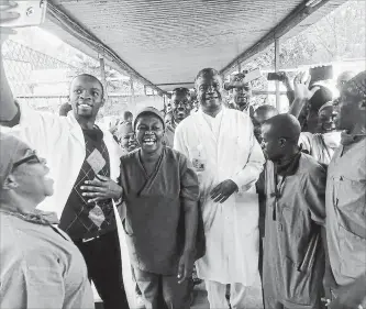  ?? THE ASSOCIATED PRESS ?? Dr. Denis Mukwege, centre, celebrates with his staff after learning he has been awarded the 2018 Nobel Peace Prize, at the Panzi hospital in Bukavu, eastern Congo, on Friday. He shares the award with Nadia Murad, an Iraqi Yazidi woman. Mukwege, 63, founded the hospital and has treated thousands of women, many of whom were victims of gang rape.