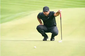  ?? AP Photo/John Minchillo ?? Jason Day lines up a shot on the 15th green during the third round of the Travelers Championsh­ip golf tournament at TPC River Highlands on Saturday in Cromwell, Conn.