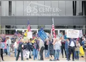  ?? ERIN HOOLEY/CHICAGO TRIBUNE ?? Protesters calling for the government to reopen Illinois rally outside the Bank of Springfiel­d Center May 20.