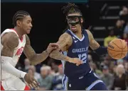  ?? BRANDON DILL — THE ASSOCIATED PRESS ?? Memphis Grizzlies guard Ja Morant, right, handles the ball against Houston Rockets guard Kevin Porter Jr., in the second half Wednesday in Memphis, Tenn.