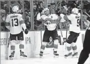  ?? Karl B DeBlaker Associated Press ?? THE PANTHERS’ Matthew Tkachuk, middle, tells teammates to exit the ice after his overtime goal.