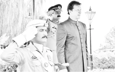  ?? — AFP photo ?? Handout photograph shows Imran Khan inspects guard of honour on his arrival in the Prime Minister House during a ceremony in Islamabad.