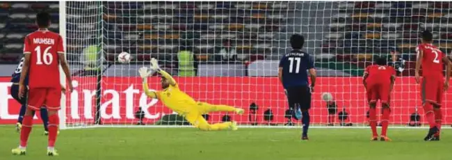  ?? AFP ?? IN VAIN: Oman’s goalkeeper Faiz Al Rushaidi fails to catch the ball as Japan’s midfielder Genki Haraguchi (unseen) scores a penalty kick during the 2019 AFC Asian Cup Group F match at Hazza bin Zayed Stadium in Abu Dhabi.–