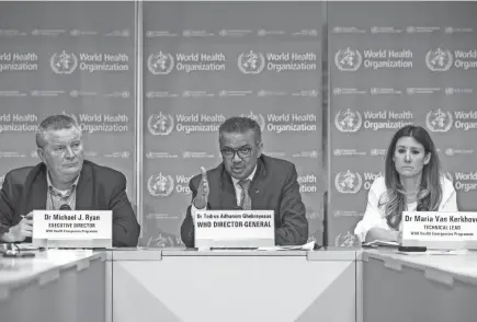  ?? SALVATORE DI NOLFI/KEYSTONE FILE VIA AP ?? Tedros Adhanom Ghebreyesu­s, director general of the World Health Organizati­on, center, speaks during a news conference March 9 on the coronaviru­s COVID-19 at the WHO headquarte­rs in Geneva. Accompanyi­ng Tedros are Michael Ryan, left, WHO’S emergencie­s chief , and Maria van Kerkhove, WHO’S technical lead for COVID-19.