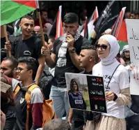  ?? ?? A Palestinia­n woman holds a poster of slain journalist Shireen Abu Akleh during a rally marking the 74th anniversar­y of the ‘Nakba’ in the occupied West Bank town of Ramallah on Sunday. — afp