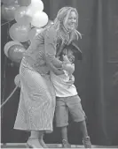  ?? ?? Graduate De’Moni Coleman hugs his teacher, Megan Kaupla, during a K5 promotion ceremony at the Milwaukee Academy of Science.
