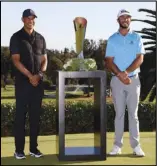  ?? Associated Press ?? HOMETOWN WINNER
Max Homa, right, poses with his trophy next to Tiger Woods on the practice green after winning the Genesis Invitation­al at Riviera Country Club on Sunday, in the Pacific Palisades area of Los Angeles.