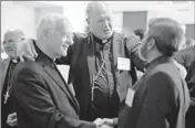  ?? By David Goldman, AP ?? Leading the efforts: New York Archbishop Timothy Dolan, center, heads the U.S. Conference of Catholic Bishops.