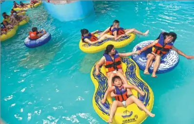  ??  ?? Visitors play at the Wanda Theme Park in Hefei, capital of Anhui province in East China on July 26th.