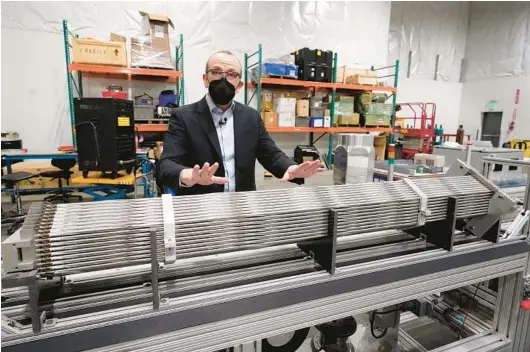  ?? ELAINE THOMPSON/AP PHOTOS ?? Chris Levesque, president and CEO of TerraPower, a company developing and building small nuclear reactors, displays a fuel assembly model.