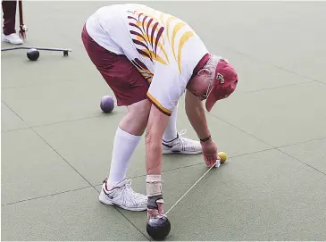  ??  ?? Gerry Wakefield has the tape measure out to check a close end, as Garfield and Drouin played in a closely fought match on Tuesday.