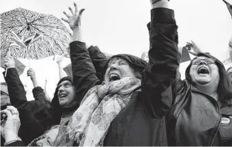  ?? Alberto Pezzali / Associated Press ?? Anti-Brexit supporters cheer outside Parliament in London on Saturday, when British lawmakers voted 322-306 to delay approval of Prime Minister Boris Johnson’s new Brexit deal.