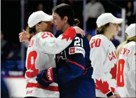  ?? AP PHOTO/ADRIAN KRAUS ?? United States forward Hilary Knight, right, hugs Canada forward Marie-Philip Poulin after Canada won the final at the IIHF Women’s World Hockey Championsh­ips in Utica, N.Y., Sunday, April 14, 2024.