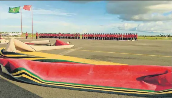  ??  ?? Wind of change: The red carpet is blown about as the plane carrying Chinese President Xi Jinping takes off from Julius Nyerere Internatio­nal Airport in Tanzania. But China’s presence in Africa, and at home, is seen as highly exploitati­ve. Photo: Thomas...