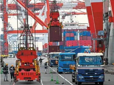  ?? — Bloomberg ?? Trade cheer: Workers in action at a port in Japan. a weaker gain in the country’s outbound shipments in March doesn’t derail a solid trend that is likely to bolster gross domestic product in the first quarter via stronger net exports and capital investment.
