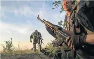  ?? Picture: AFP ?? INSURGENTS: Separatist rebels during the battle for a Ukrainian village bordering Russia near Snezhnoye this week