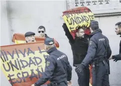  ??  ?? 0 Right-wing protesters hold flags saying ‘Long live a united Spain’