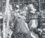  ??  ?? LIVING FOR TODAY: Mourners add to a floral tribute outside the building where John Lennon was killed, in New York in 1980.