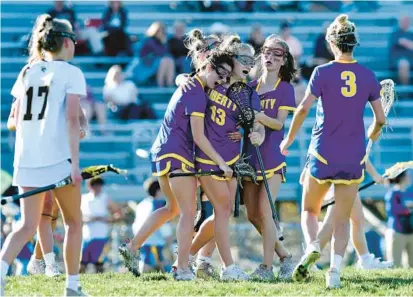  ?? DYLAN SLAGLE/CARROLL COUNTY TIMES ?? Teammates celebrate with Liberty junior Jenna Evans (13) after she scored in the second half of the Lions’ Class 1A West Region I championsh­ip victory over South Carroll on Monday.