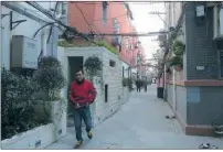  ?? GAO ERQIANG / CHINA DAILY ?? A man leaves after using an old-style public restroom located in Ruikangli on 828 East Beijing Road.