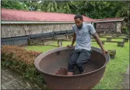  ?? (The New York Times/Tony Cenicola) ?? An estate worker at Fond Doux Eco Resort outside Soufriere, St. Lucia, stomps on cacao beans, which aids the shelling process.