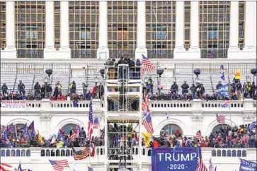  ?? John Minchillo Associated Press ?? PRO- TRUMP rioters storm the U. S. Capitol. “Any society has people with a strong authoritar­ian impulse,” said Erwin Chemerinsk­y, law school dean at UC Berkeley. “What the Constituti­on does is create guardrails.”