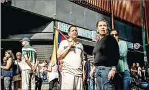  ?? MERIDITH KOHUT/THE NEW YORK TIMES ?? Venezuelan­s wait to cast ballots in a symbolic poll organised by opposition political parties in Caracas, Venezuela, on Sunday.