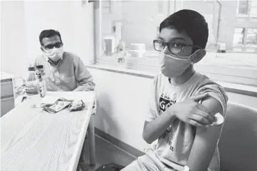  ?? CINCINNATI CHILDREN’S HOSPITAL ?? An undated photo shows 12-year-old Abhinav, a participan­t in the Pfizer vaccine trial at an Ohio hospital. Pfizer and Moderna are testing their vaccines on children 12 and older and hope to have results by the summer.