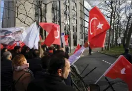  ?? OLIVIER MATTHYS — THE ASSOCIATED PRESS ?? Pro-Erdogan supporters wave flags and banners in Brussels on Monday.