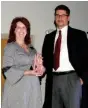  ?? / Doug Walker ?? Stephanie Nichols presents the Chamber Ambassador of the Year Award to Quinton Schwengel of Keller Williams Realty.