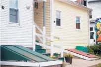  ?? SOFIE BRANDT/HARTFORD COURANT ?? Crime scene tape wraps stairs leading to an Enfield apartment where two people were killed Sunday night.