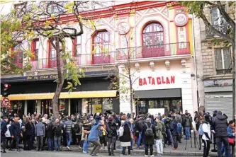  ??  ?? In this file photo people stand in front of the Bataclan concert venue during ceremonies across Paris marking the second anniversar­y of the terror attacks of November 2015 in which 130 people were killed, in the French capital. — AFP