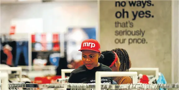  ?? Picture: Moeletsi Mabe ?? A shop assistant at the MRP store in Sandton City, Gauteng. Mr Price Group’s large stores, stocking a range of brands, have enabled it to remain competitiv­e in a difficult retail environmen­t.