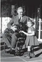  ?? M.L. Suckley /AP ?? President Franklin Roosevelt holds Fala while talking to Ruthie Bie, granddaugh­ter of the caretakers of the Hill Top Cottage at his Hyde Park, N.Y., home in this Feb. 1941 file photo.
