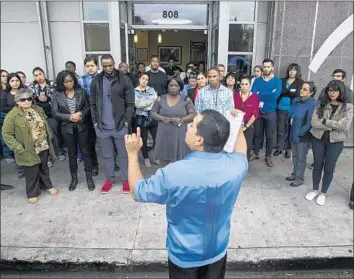  ?? Gina Ferazzi Los Angeles Times ?? MARIO CHAVEZ of St. John’s Well Child & Family Center briefs workers last month on how to respond if federal immigratio­n agents visit their clinics. They have practiced linking arms to block entry to the facility.