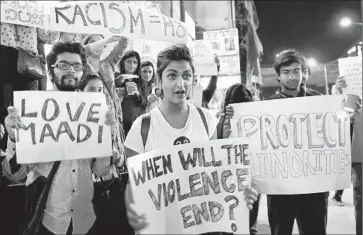  ?? Manjunath Kiran AFP/ Getty I mages ?? I NDIAN college students rally in support of a Tanzanian woman, 21, who was apparently pulled from her car, stripped and sexually assaulted in Bangalore. An accident may have been the catalyst for the attack.