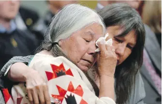  ??  ?? Residentia­l school survivor Lorna Standingre­ady is comforted during the closing ceremony of the Indian Residentia­l Schools Truth and Reconcilia­tion Commission in Ottawa in 2015.