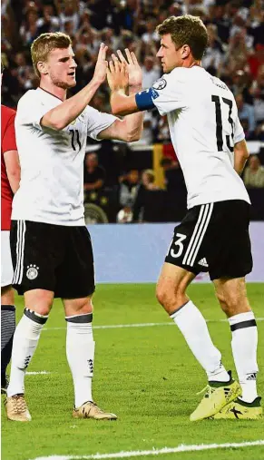  ??  ?? Germany forward Timo Werner (left) is congratula­ted by teammate Thomas Mueller after scoring against Norway in the World Cup qualifying match in Stuttgart on Monday. — AFP Well done: