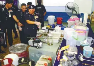  ??  ?? Mohmad (foreground) and his officers showing some of the items seized.