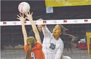  ?? DYLAN BIDA/RIO GRANDE SUN ?? Pojoaque Valley’s Ashten Martinez, right, sends a shot past Los Lunas blocker Jaidyn Schollande­r during Friday’s quarterfin­als of the Class 4A State Volleyball Tournament in Rio Rancho. Pojoaque Valley teammates lost in five games, ending their season.