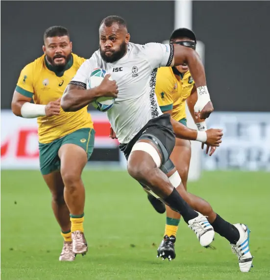  ?? Photo: RWC 2019 ?? Fiji Airways Flying Fijians flanker Peceli Yato brusts through the Australian Wallabies defence during last year’s Rugby World Cup in Sapporro, Japan. Now the Flying Fijians Test match against Australia set for July is in doubt as World Rugby looks at other options.